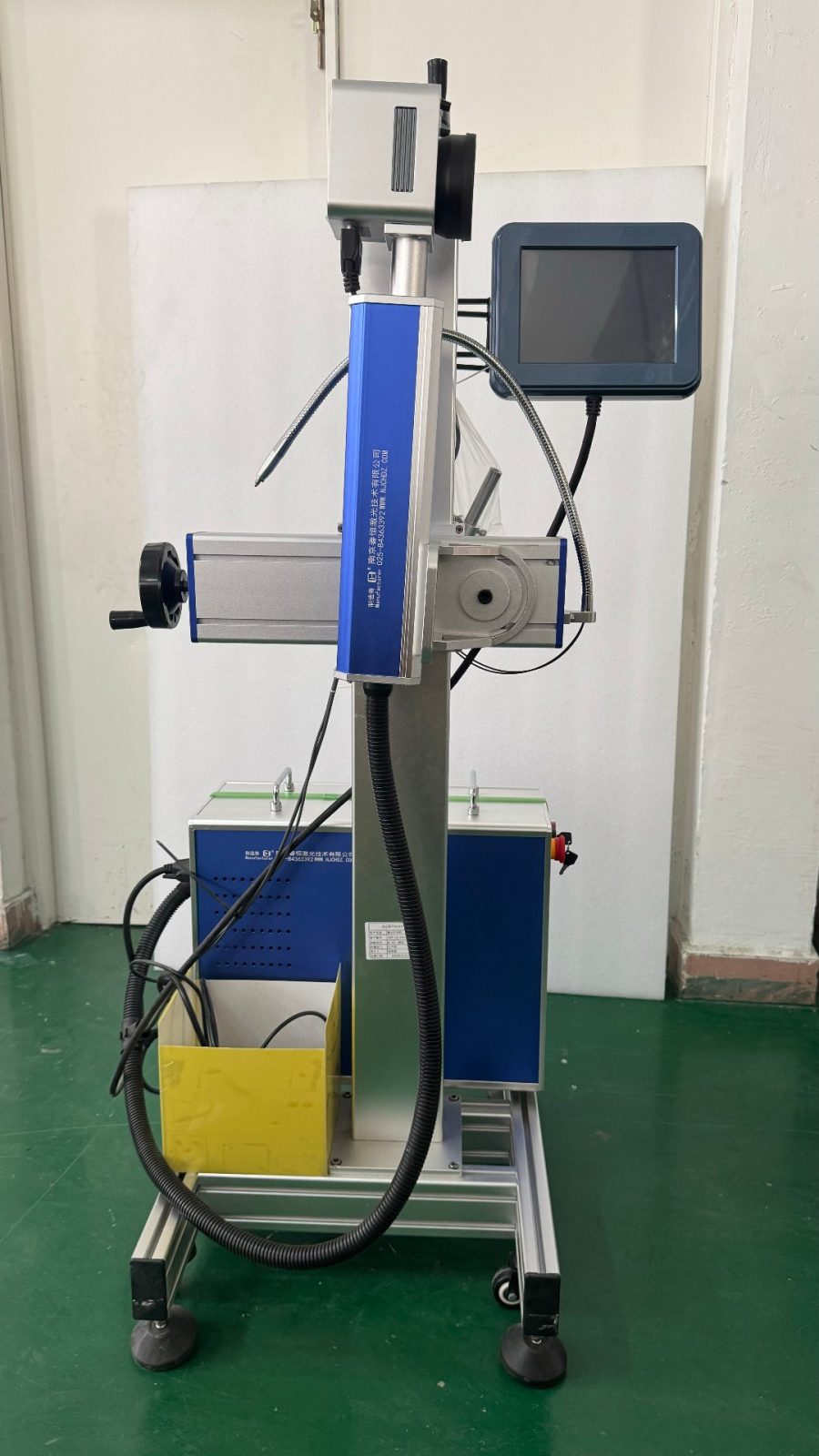 NovaBESS production equipment: blue-and-white industrial laser marking machine used for battery case engraving or welding